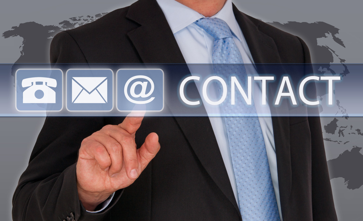 Contact us - Businessman touching screen with finger